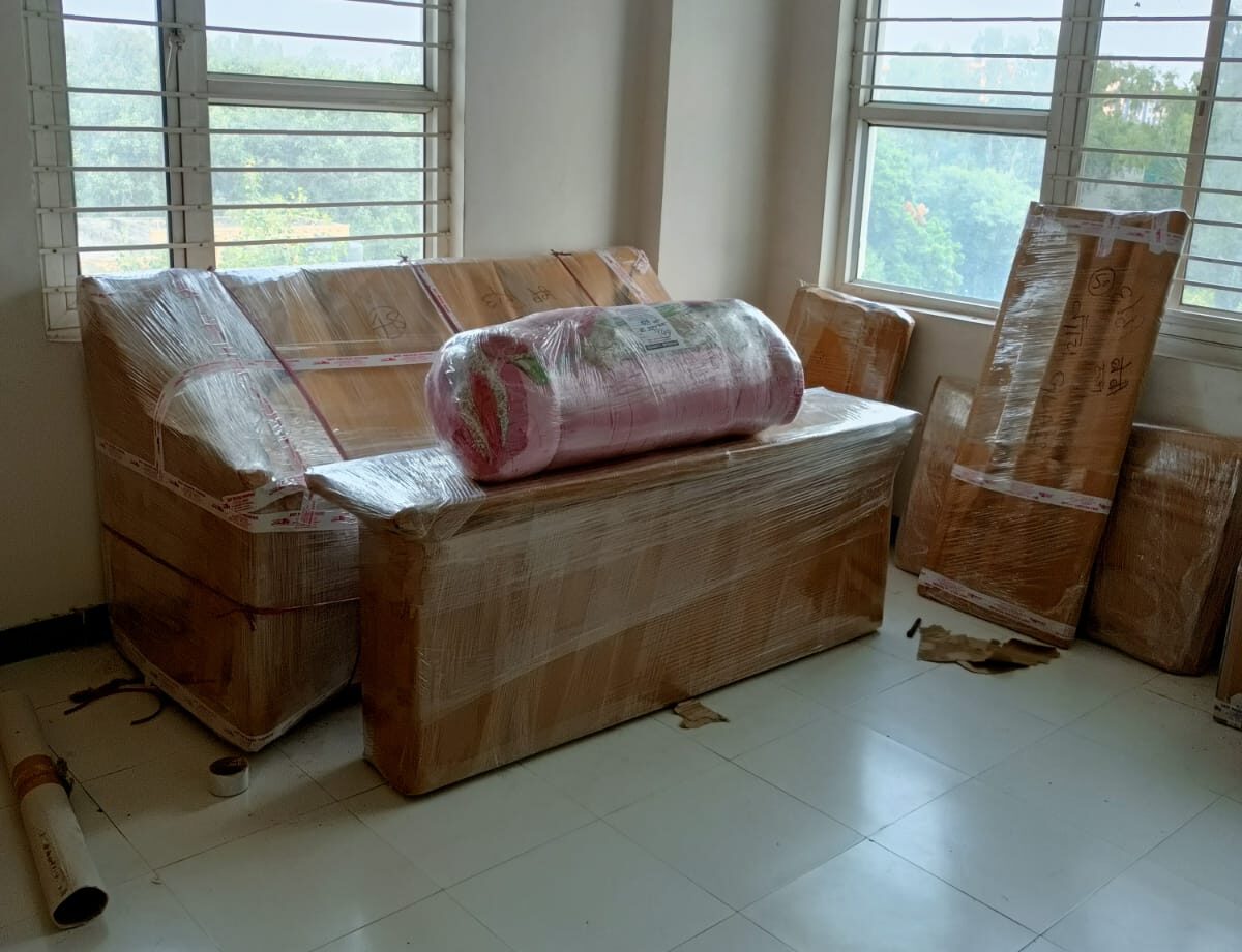 Corporate relocation service showing office movers packing IT equipment and labeled cartons