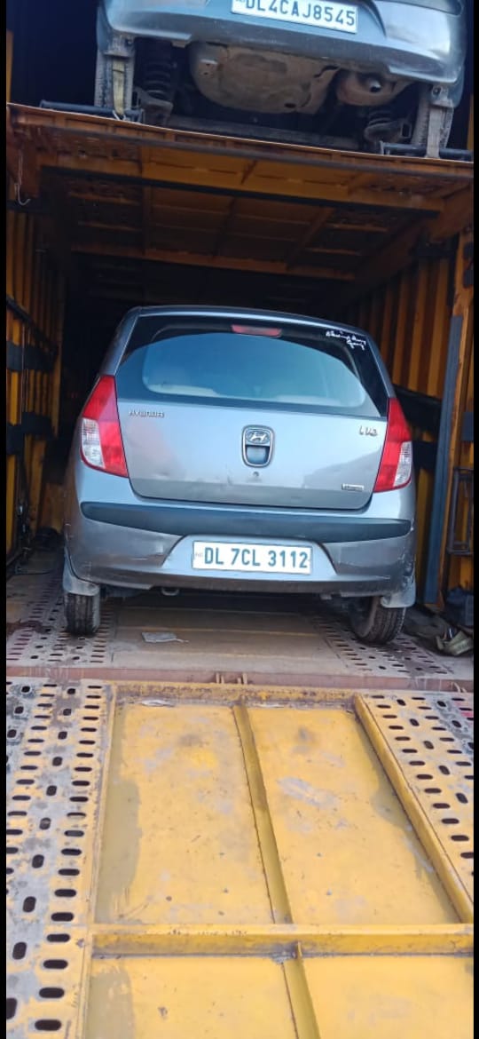 Car being prepared for safe vehicle transport and carrier loading